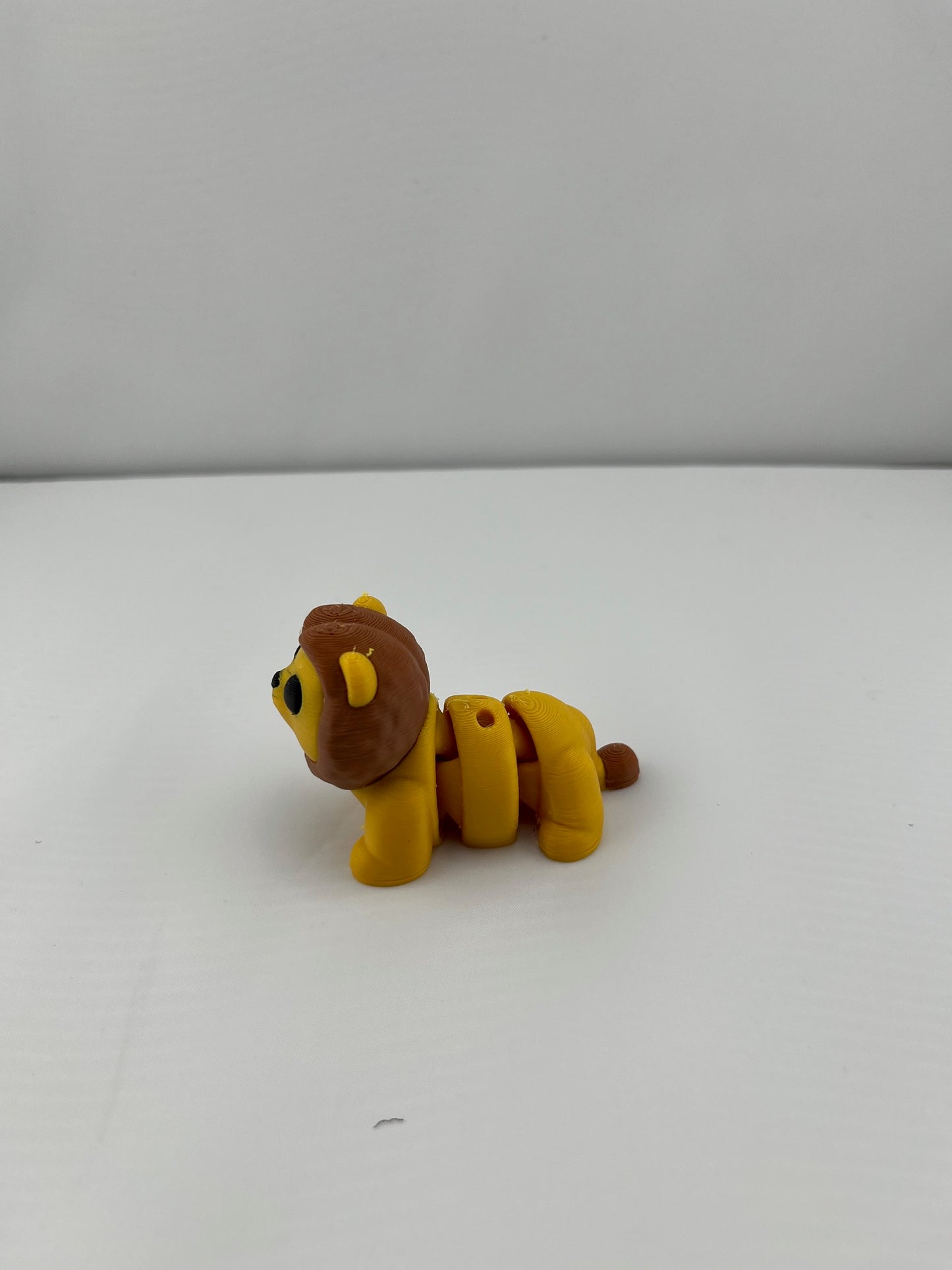 Flexible Articulated Lion - Tiny 3D Printed Fidget Toy - Various Sizes Available - Team Mascot - Use as a fund raiser for school - Collect them all - Stress relief - ADHD - Key Chain - Zipper Pull - Pal for your pocket - MADE IN THE USA